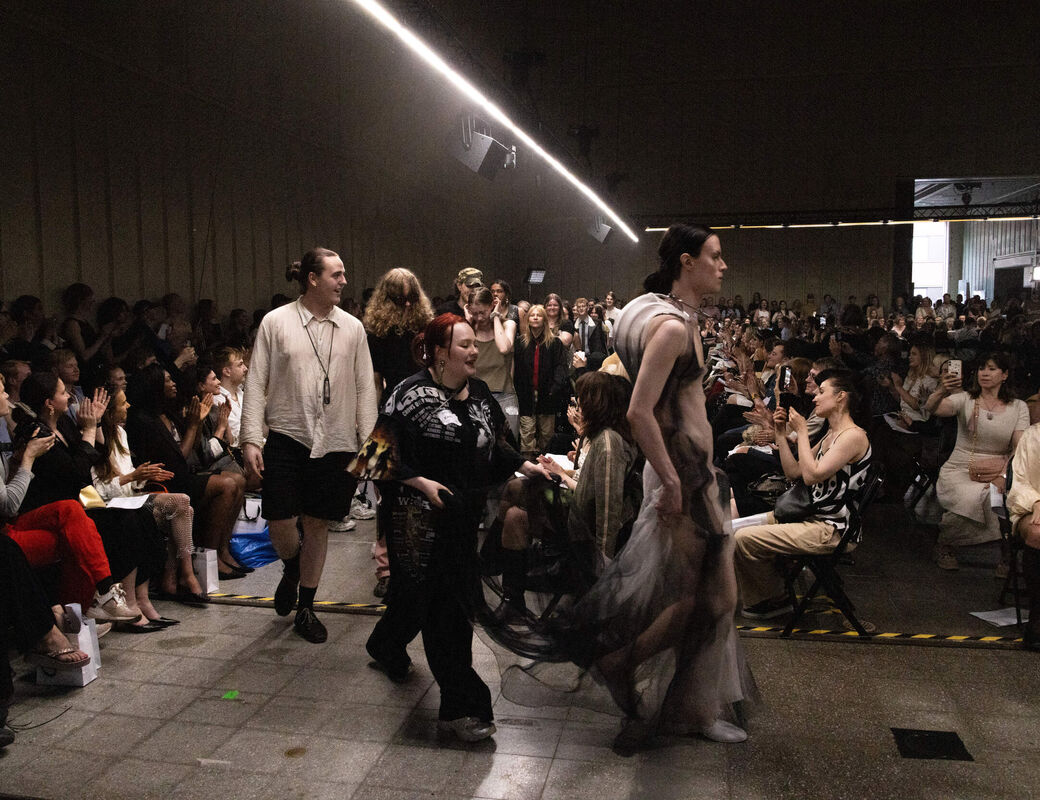 Models and fashion designers walking on the catwalk