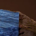 a blue colored print marking water has been placed on a rock to showcase the rising of water due to climate change 