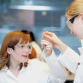 Two women analysing the content of a test tube