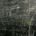 Blackboard filled with figures and equations