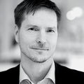 Black & white face image of smiling Matti Kuittinen.