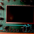 A green audio board of circuits with black knobs and the sentence "Why do we do the things we do?" written in white font in capitals.