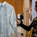 Woman touching a long-sleeved Marimekko Unikko shirt on display