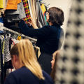 students browsing clothes in a clothes rack