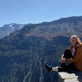BScBA alumna Julia Romanyuk sitting in front of mountain landscape