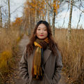 The picture shows Master's student Yijuan Wei outdoors in the Finnish nature in Otaniemi in the autumn.