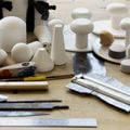 Workshop table full of tools for working with plaster and clay
