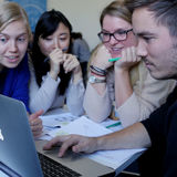 Creative Sustainability students gathered around a laptop