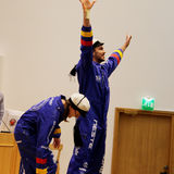 An image of two students wearing blue overalls