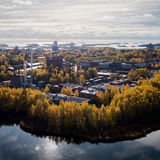 An autumnal aerial view of Aalto University campus from Laajalahti, autumn colours, yellow and orange, are prominent in the trees