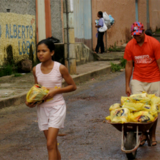 A girl and a man selling items in Brazil