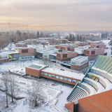 Drone image of Otaniemi campus in early December, light covering of snow everywhere, with low sun shining