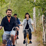 Three students cycling in Otaniemi in the summer