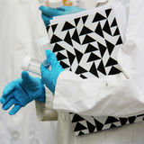 Lab coat, folder and lab gloves. Photo by Aalto University, Kitty Norros
