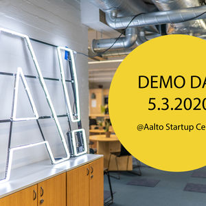 Aalto University logo as light sign next to a circle with the text Demo Day 5.3.2020 @Aalto Startup Center in it