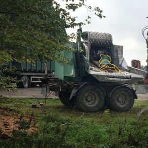 Photo of a leaf shredder with a man drawn over the photo as being crushed by the machine