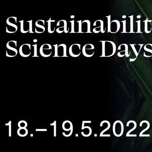 White Sustainability Science Days text and a date: 18.–19.5.2022. Dark colored image with some green vegetations visible in the background. At front, on the right down corner, white skin colored human hand holding a wooden stick with a snail. White Aalto University, HELSUS and University of Helsinki Logos on the top right of the image.