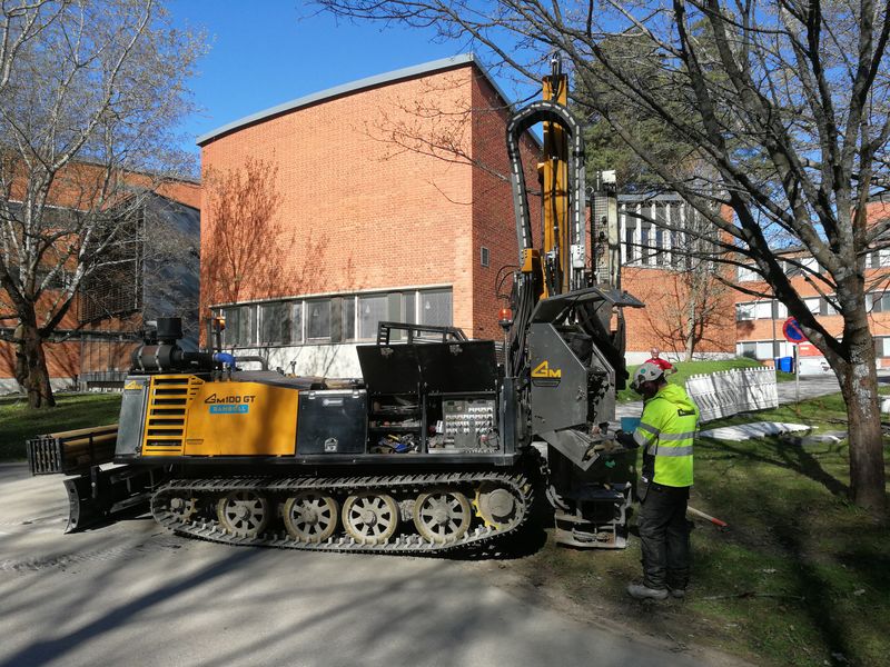 A construction worker reparing a drilling rig on the Otaniemi campus.