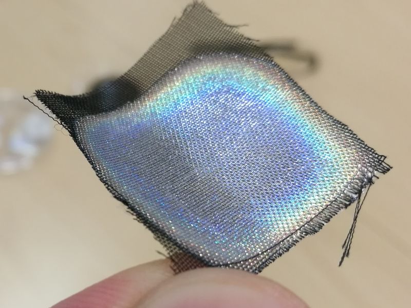 A photo demostrating the use of cellulose nanocrystals (CNC) for structural color on a piece of fabric.