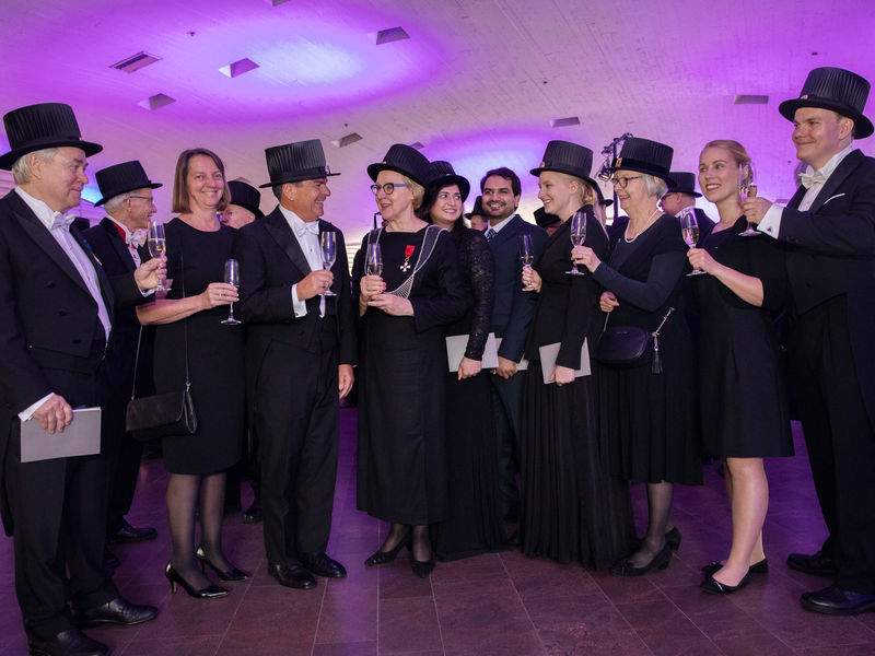 A group of doctors toasting at a Conferment party.