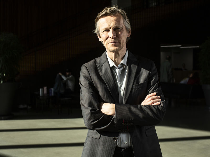 Professor Jukka Pekola stood in a hallway smiling at the camera