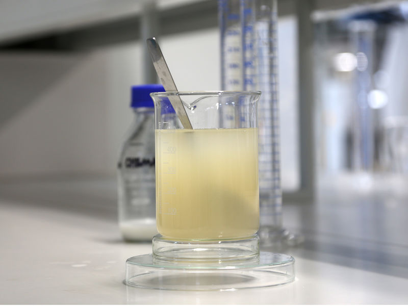 Yellowish biobased liquid in a cup in laboratory