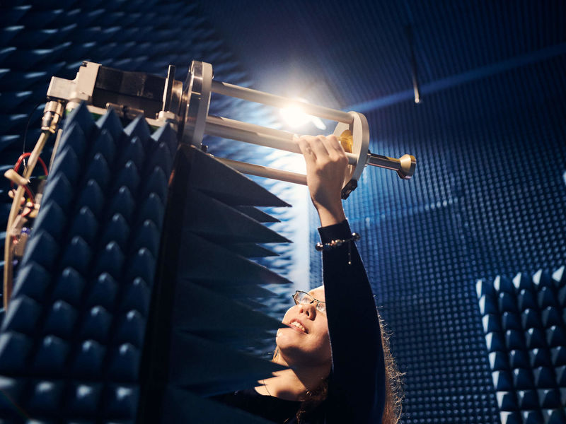 Microwave engineering student working in an anechoic chamber.