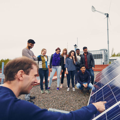 Group of students and solar panels