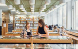 Two women reading in the library