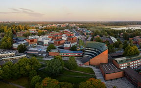 An aerial photo of the Aalto University campus at sunset.