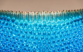 Artworkd from Dipoli, dozens of drop-shaped blue glass artefacts