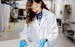 A woman working with material in the lab