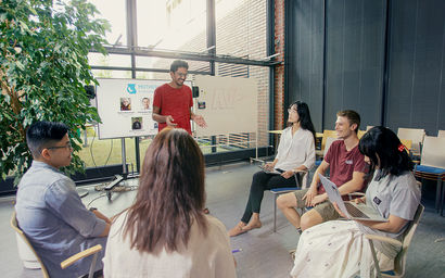 A group of students working on a presentation at Aalto Ventures Program