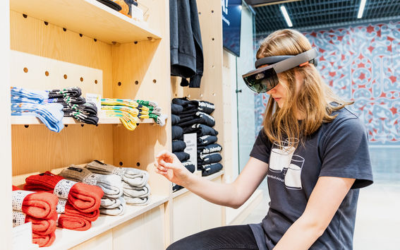 Aalto University / Emma Niemenmaa trying out VR glasses in Aalto Shop / photo: Atte Leskinen
