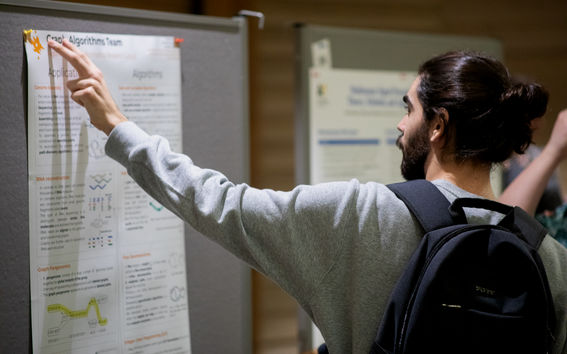 Person pointing a research poster