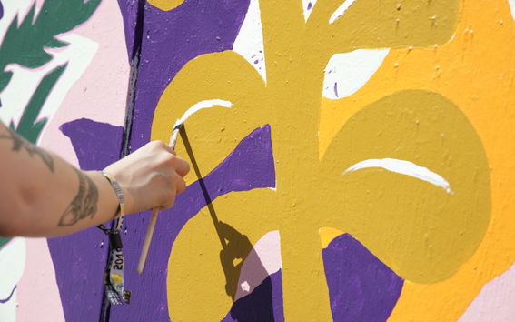 Juliana Hyrri painting a mural at Flow Festival