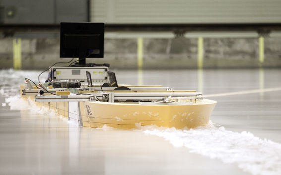 Model ship through ice in Aalto Ice Tank basin
