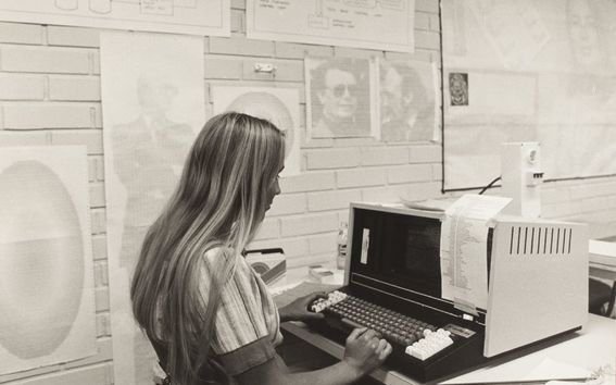 A person using a computer in a historical setting.