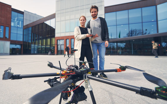 Geoinformatics students operate a drone at Aalto University.