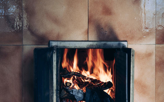 A fire in a fire place, photo by Aleksi Poutanen