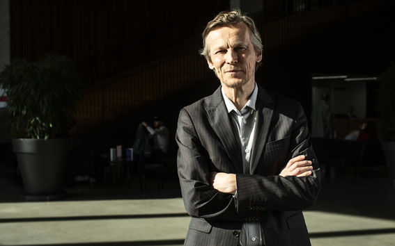 Professor Jukka Pekola stood in a hallway smiling at the camera