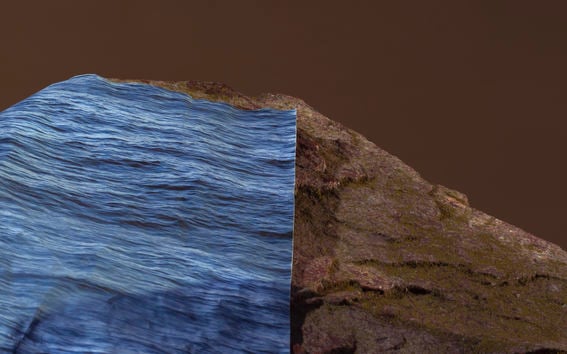 a blue colored print marking water has been placed on a rock to showcase the rising of water due to climate change 
