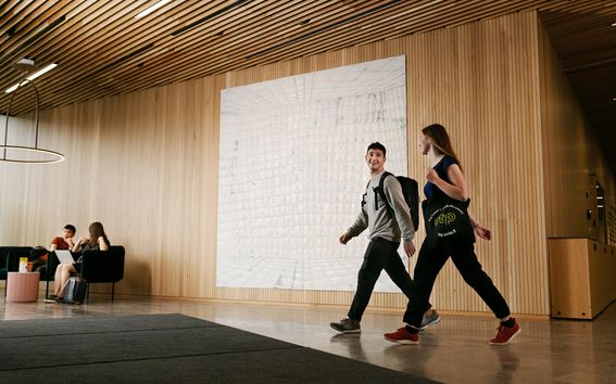 Students walking through the School of Business lobby