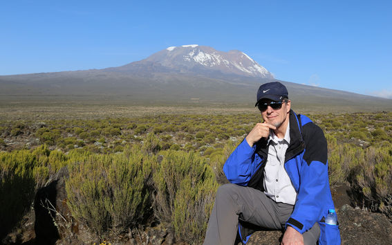 Dr. David Volkman in Kenya with Mount Kilimanjaro in the background.