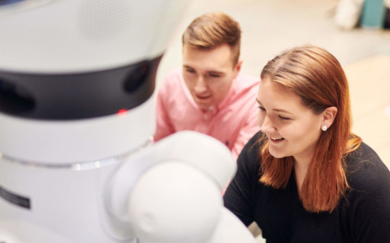 two students with a robot image unto rautio