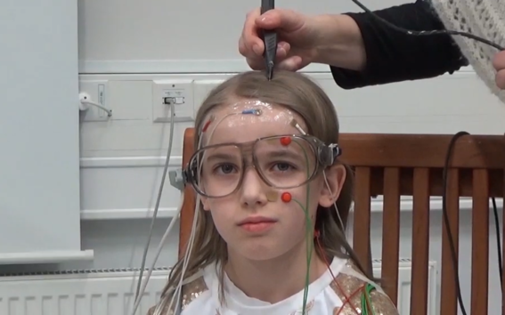 Magnetoencephalography (MEG) was used to study reading difficulties in children. This photo shows preparations for the measurement test. The child in the photo was not part of the study. Picture : Aalto University.