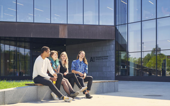 Business students in the front of the School of Business