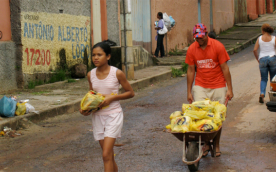 A girl and a man selling items in Brazil