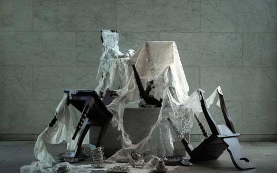 an installation with chairs and tableware