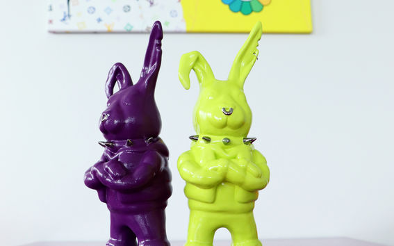 two ceramic rabbits standing on a table